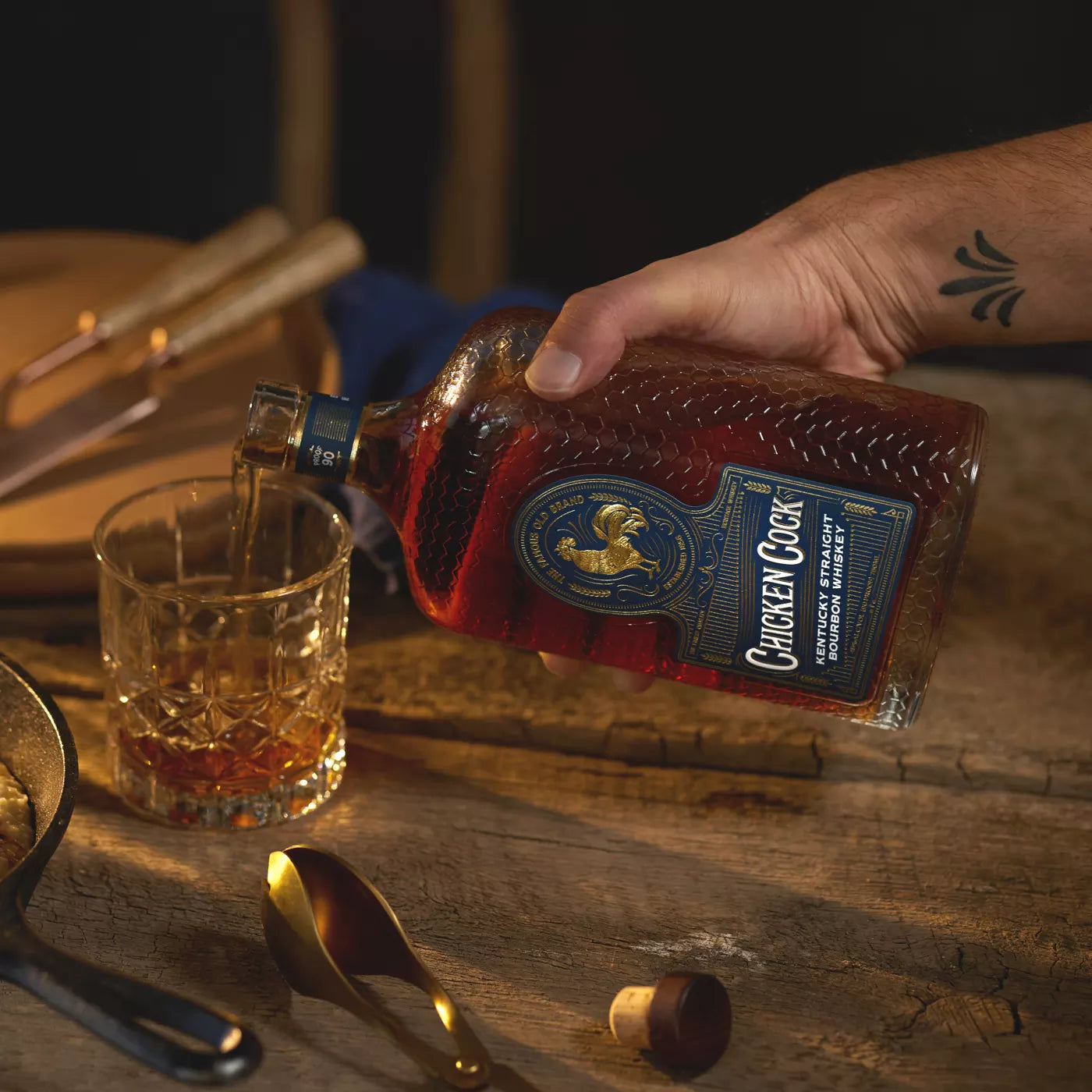 Chicken Cock whiskey being poured into a glass